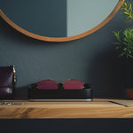 Head On Image of Black Italico Luxury Glasses Valet sitting with Dior sunglasses sitting on an entry way foyer table