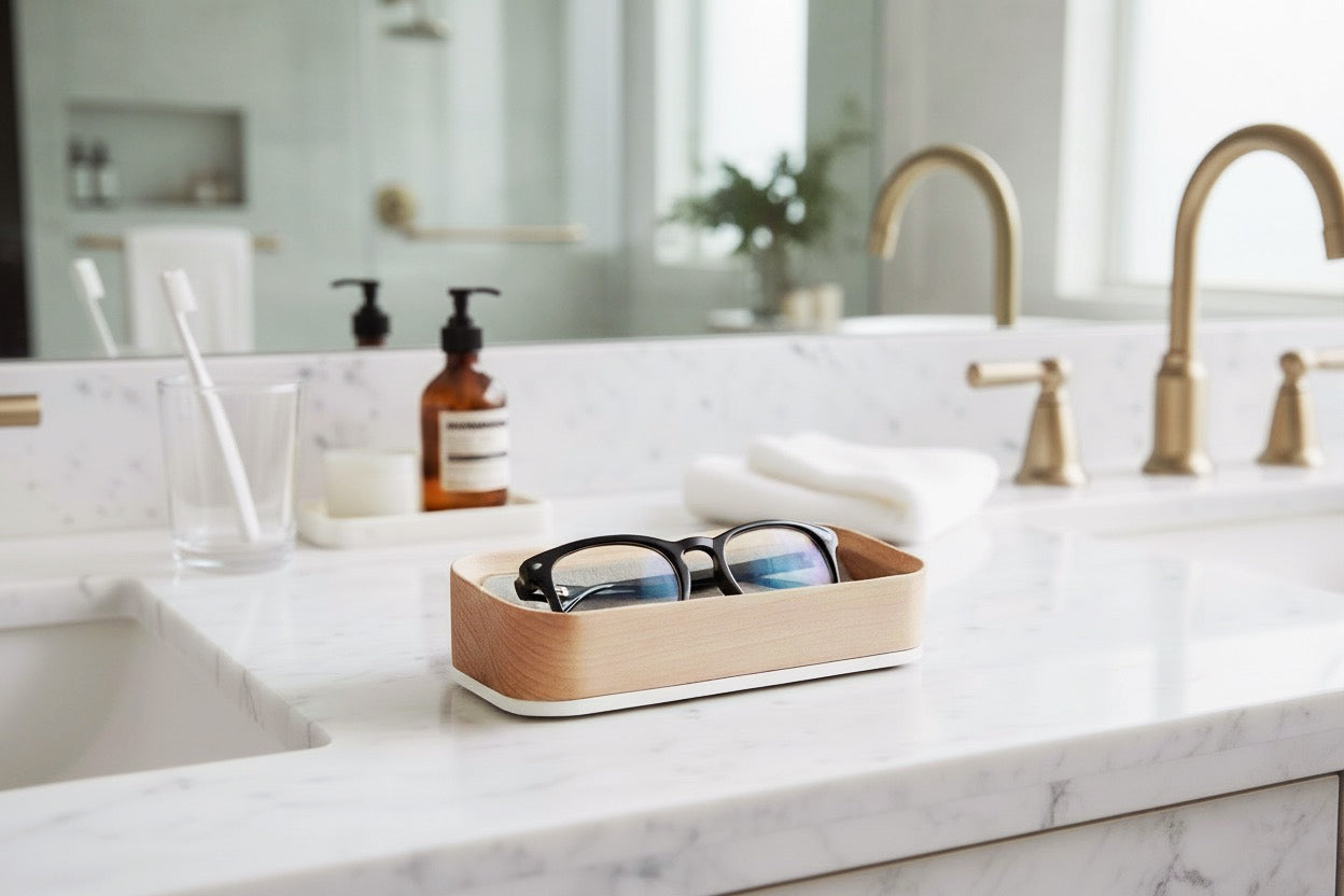 Bright Sunny Lifestyle Image of White Maple Italico Luxury Glasses Valet on a bathroom counter near a sink with black glasses nested inside